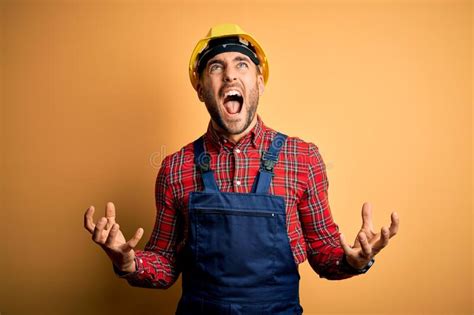 Young Builder Man Wearing Construction Uniform And Safety Helmet Over