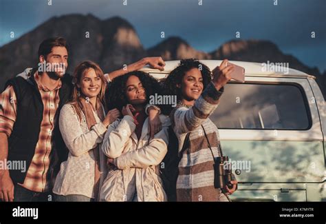 Group Of Mixed Race Friends Taking A Selfie Near The Van Young Man And Women Together On Road
