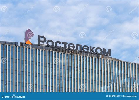 The Glass Facade Of A Modern Building With A Large Rostelecom Sign On The Roof Rostelecom Is