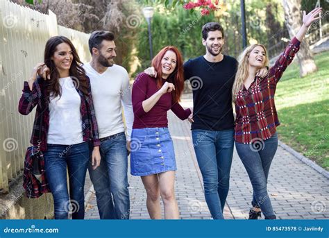 Group Of Young People Together Outdoors In Urban Background Stock Photo