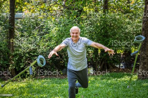 Rehabilitated Senior Man Throwing His Crutches Stock Photo Download
