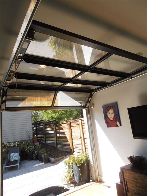 Glass Garage Door To Outdoor Patio Area Opens Entire Wall To The