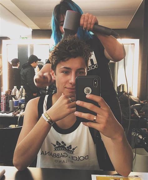 A Man Taking A Selfie In Front Of A Mirror With His Hair Dryer