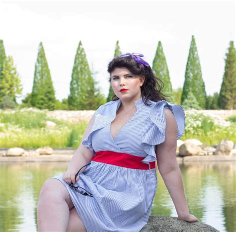 Young Beautiful Plus Size Model In Dress Near The Lake Stock Photo