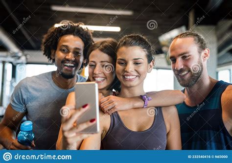 Group Of Sportive People In A Gym Having Fun Taking Selfie Stock