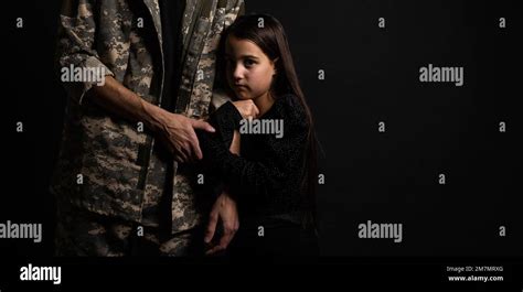 Masculine Sad Military Man Hugging Her Upset Daughter Indoors Stock