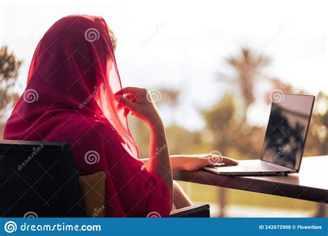 Silhouette Of Muslim Arab Woman In Red Head Scarf Hijab Sitting At