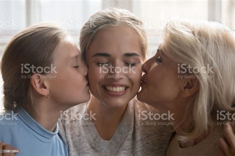 Closeup Faces Woman Her Daughter And Elderly Mother Kiss Her Stock