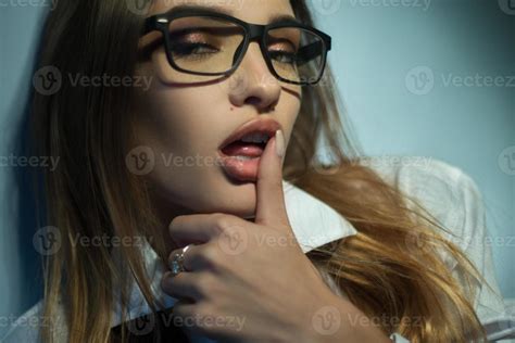 Seductive Blonde In Glasses With Open Mouth Licks Her Finger And Looks To The Camera 16100462