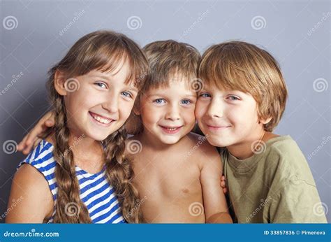 Cute Sister Hugging Younger Brothers Stock Photo Image Of Little