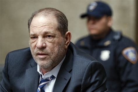 harvey weinstein puts his head in his hands as judge rules he can be transferred to la to face