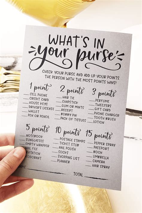 a hand holding up a printable wedding game with the words what s in your purse on it