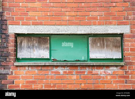 Three Boarded Up Windows Set In Red Brick Wall Stock Photo Alamy