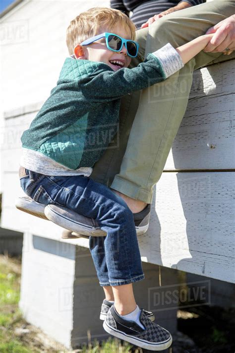 Boy Hugging Parents Legs Close Up Stock Photo Dissolve