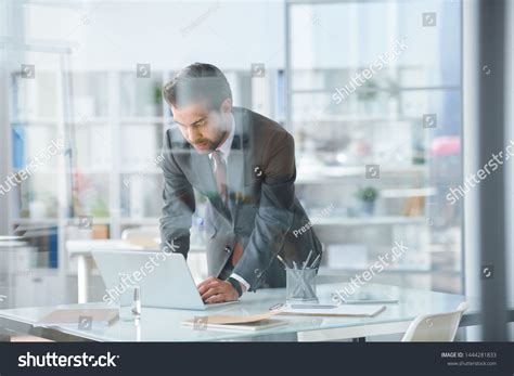 Young Elegant Businessman Bending Over Desk Stock Photo 1444281833