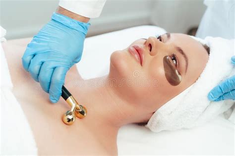 Beautiful Woman Having Face Massage With Ball Roller By Cosmetologist Stock Image Image Of