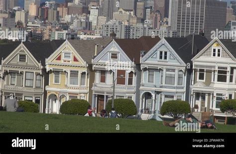 Famous Victorian Row Houses In San Francisco Tourist People Relax On