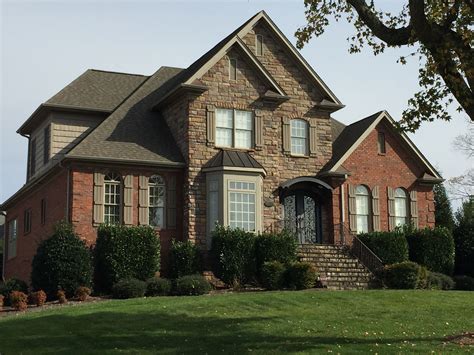 Red Brick And Stone Combine With Rock Taupe Gray Roof And Shutters To Create A Modern Country