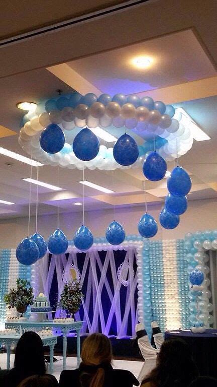 Blue And White Balloons Are Hanging From The Ceiling Above A Party Room