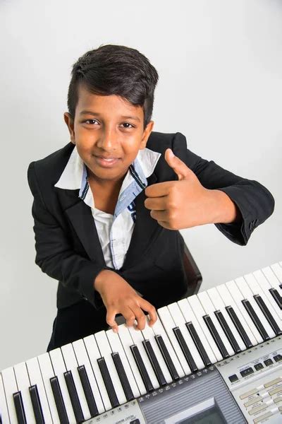 Indian Kids Playing Piano Or Keyboard A Musical Instrument ⬇ Stock