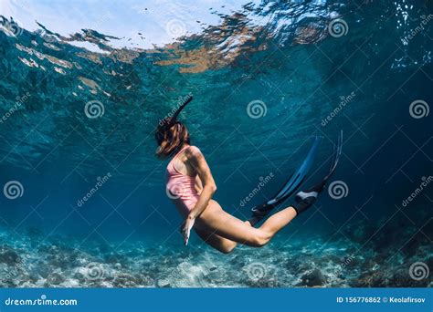 Woman Freediver Swim In Pink Swimsuit Underwater With Fins Freediving