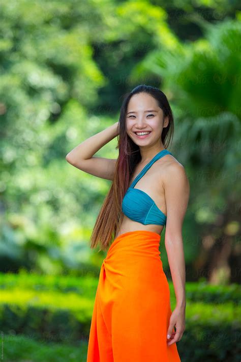 Pretty Young Asian Or Chinese Woman Wearing Bikini In The Garden By