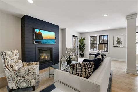 Open Living Room With Natural Lighting And A Black Shiplap Fireplace Hgtv