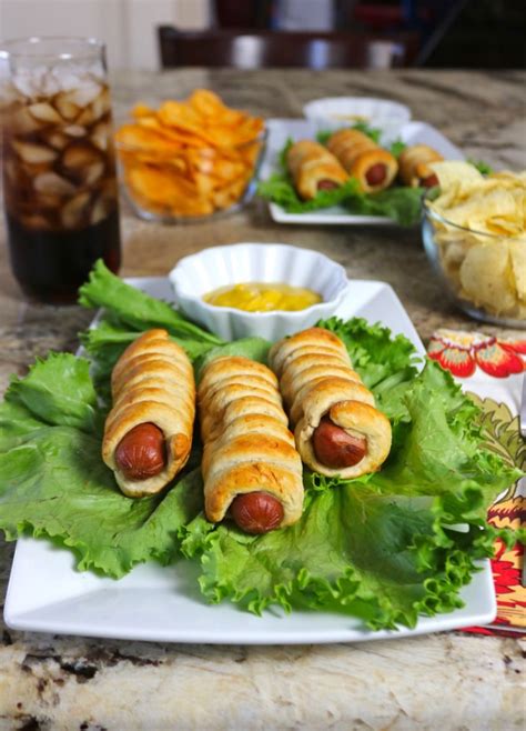 Starting at one end of the hot dog, wrap the dough strip around the hot dog leaving about ½ inch of hot dog exposed at each end. Easy Recipe: Spiral Pretzel Hot Dogs Recipe - Happy and Blessed Home