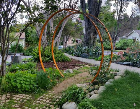 A natural garden pathway is even more welcoming with this Gracie Modern Arbor. TerraTrellis.com ...