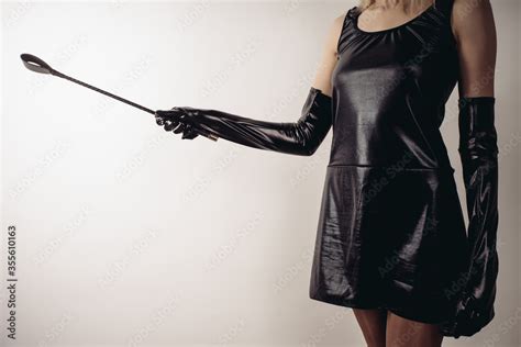 Sexy Lady Holding Strict Leather Short Handle Wide Head Riding Crop