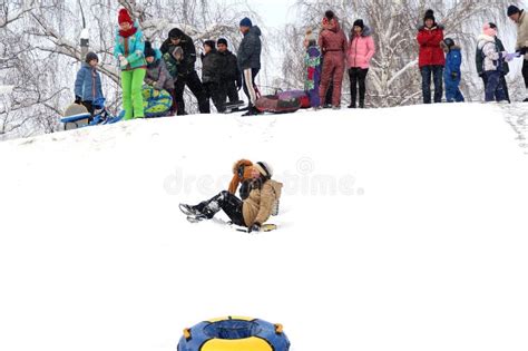Children And Adults Having Fun On A Snow Hill Editorial Stock Photo