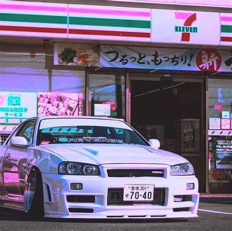 A White Car Parked In Front Of A Store