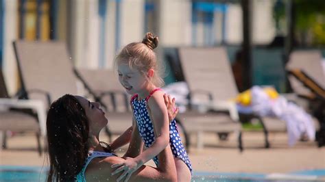 Beautiful Mother Have A Good Time With Daughter In The Swimming Pool