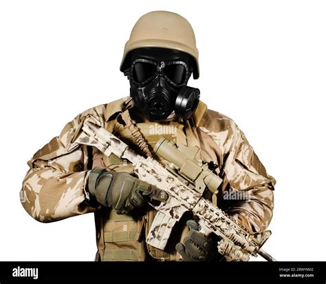 isolated photo of a fully equipped soldier in uniform armor helmet and gas mask standing with