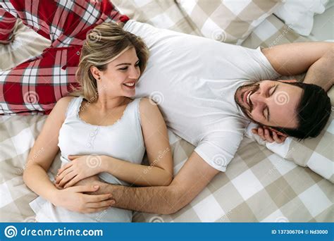 Portrait Of Young Loving Couple In Bedroom Stock Photo - Image of family, bedroom: 137306704