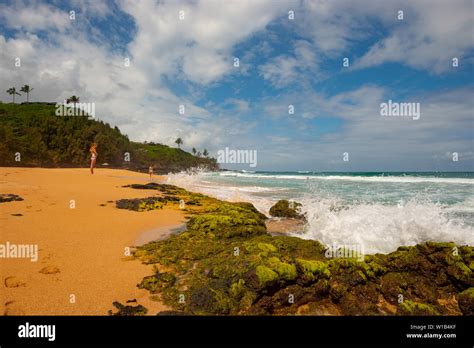 People Enjoying The Secret Beach On The Hawaiian Island Of Kauai Stock