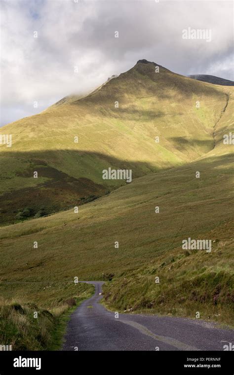 A Narrow Mountain Pass Road Climbs Caherconree In The Slieve Mish