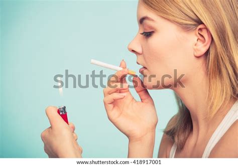 Pretty Girl Smoking Cigarette Using Lighter Stock Photo 418917001