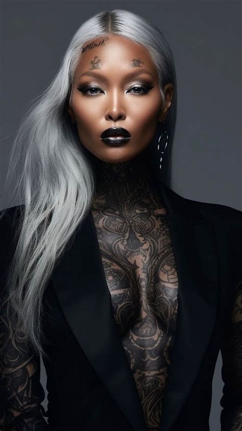 A Woman With Grey Hair And Tattoos On Her Body