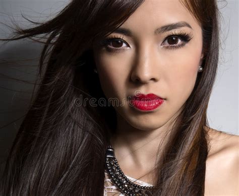 Young Beautiful Asian Woman With Flawless Skin And Perfect Make Up And