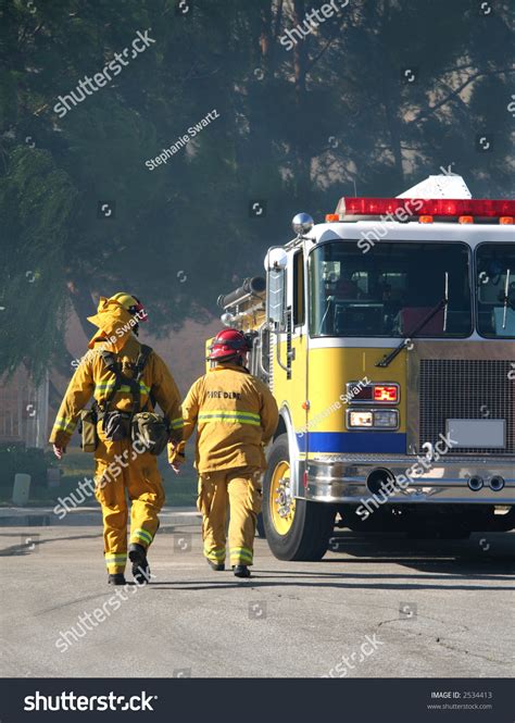 Firefighters Walking Toward Firetruck Stock Photo Edit Now 2534413