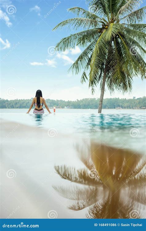 Woman Relaxing In Infinity Swimming Pool Stock Photo Image Of Luxury