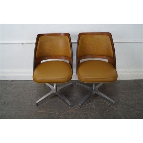 A pair of contemporary mid century modern style swivel chairs. Brody Mid-Century Walnut Barrel Back Swivel Chairs - Pair ...
