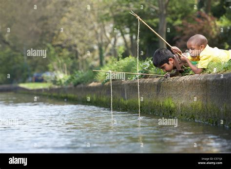 Boy Fishing On Riverbank Hi Res Stock Photography And Images Alamy