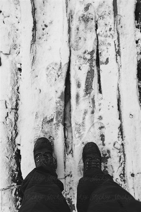 Feet Crossing A Snowy Bridge By Stocksy Contributor Shikhar