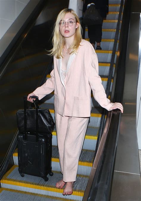Elle Fanning Goes Barefoot At LAX After Her Feet Get Too Swollen For Heels