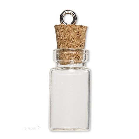 A Small Glass Bottle With A Cork Top On A White Background And A Metal