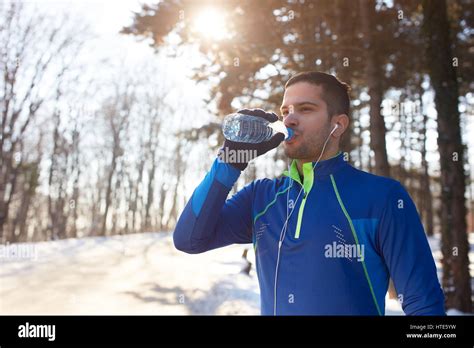 Thirsty Male Athlete Drinking Water After Running Outdoor Stock Photo