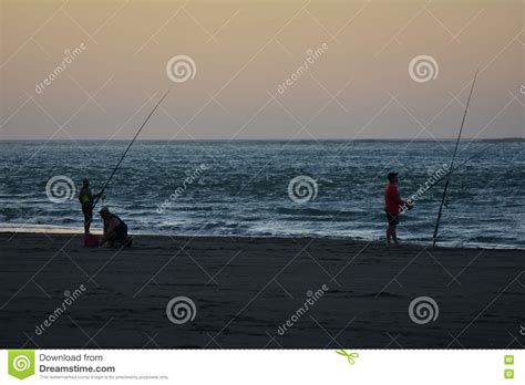 Fishing On Beach At Dusk Editorial Image Image Of Angler