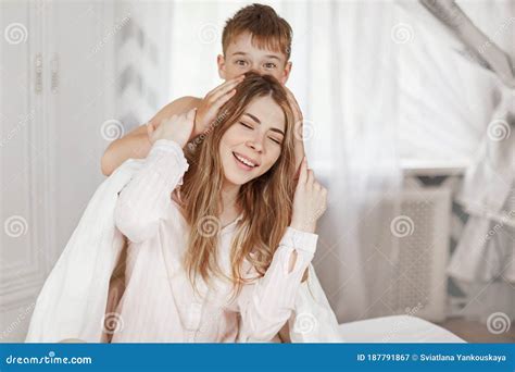 Charming Girl And Her Little Brother Fool Around On The Bed In The Morning After Sleeping
